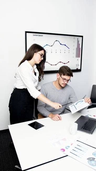 An open planner on a desk with a handwritten note reading Holiday Email Marketing Series.